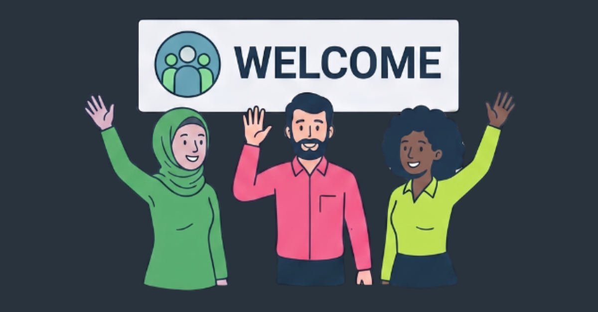 A diverse team of colleagues underneath a welcome sign smiling and waving